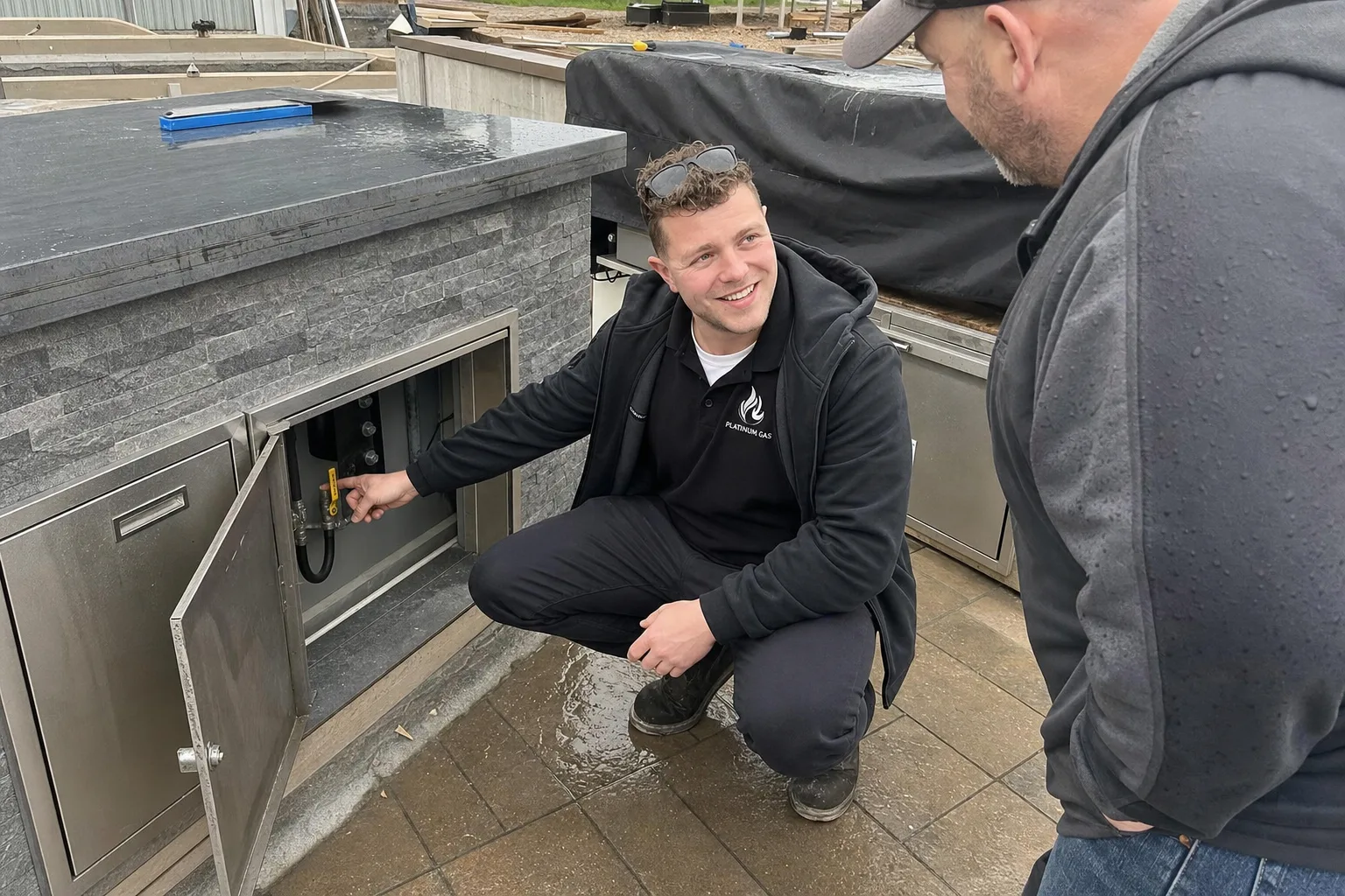 Reilly Morrison reviewing an outdoor-kitchen gas connection with a homeowner - Platinum Gas Reilly Morrison reviewing an outdoor-kitchen gas connection with a homeowner