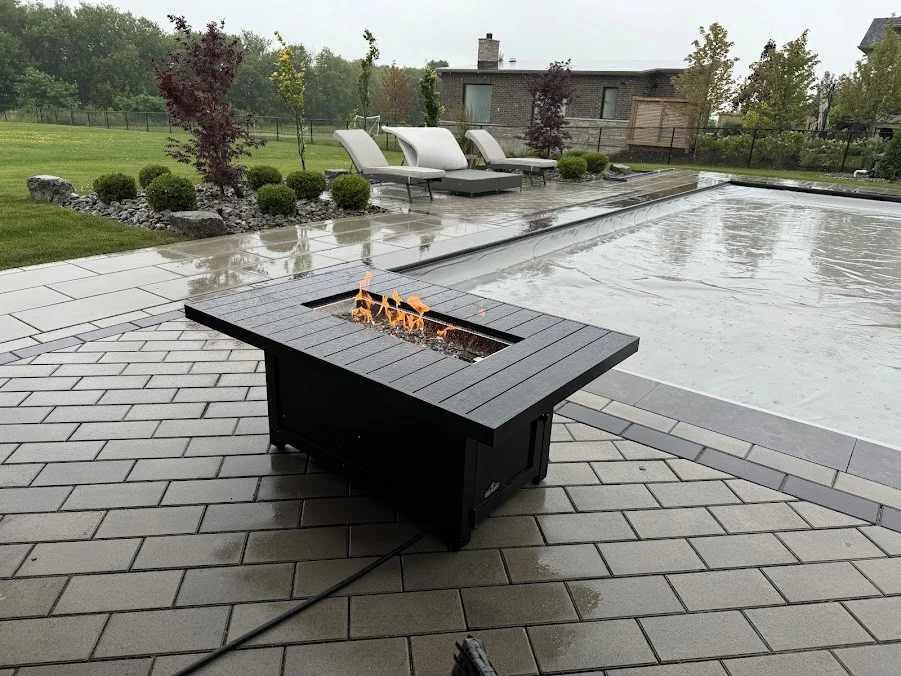Platinum Gas project photo of an outdoor gas fire table beside a swimming pool