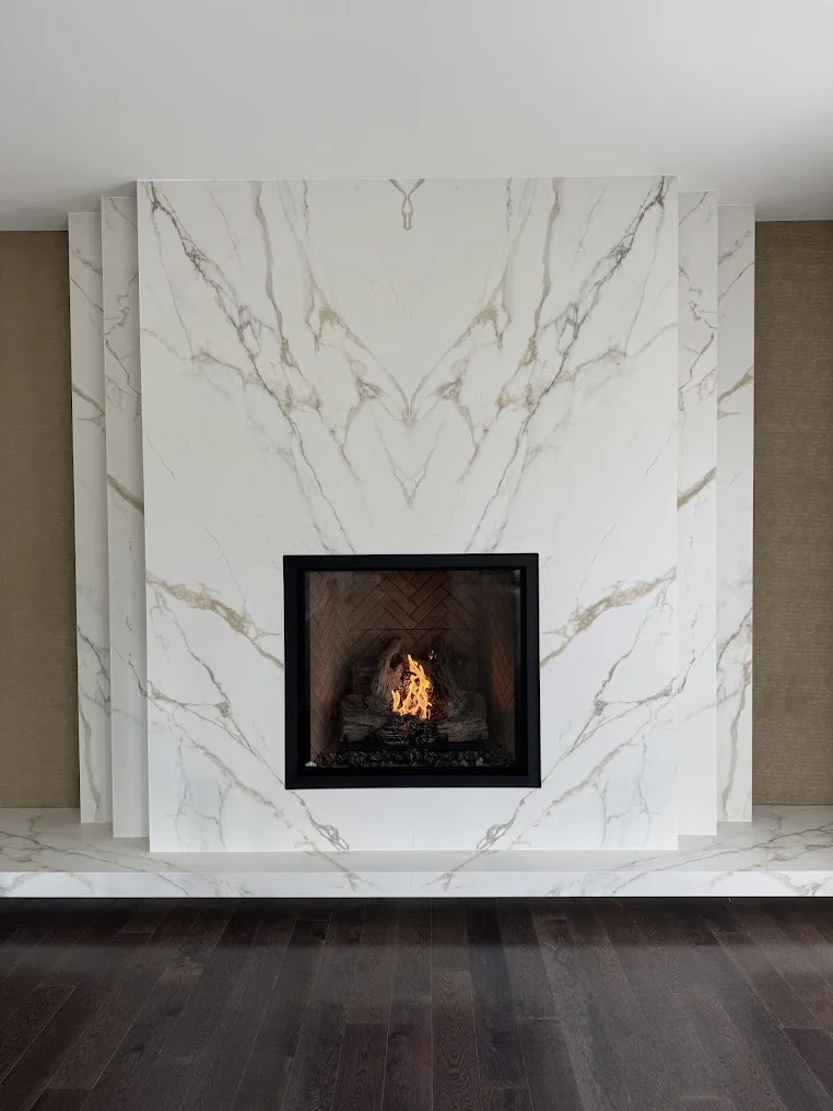 Gas fireplace in a full-height white marble surround