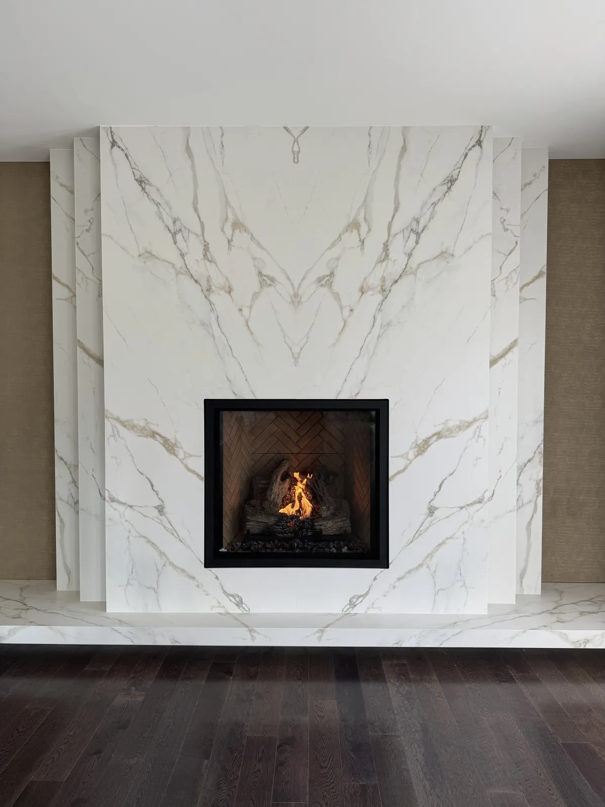 Gas fireplace in a white marble feature wall, shared by Platinum Gas